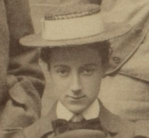 Formal photograph of woman stood outside. She is wearing a hat.