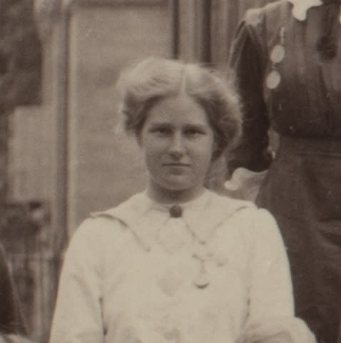 Formal photograph of woman standing outside. She is facing the camera.