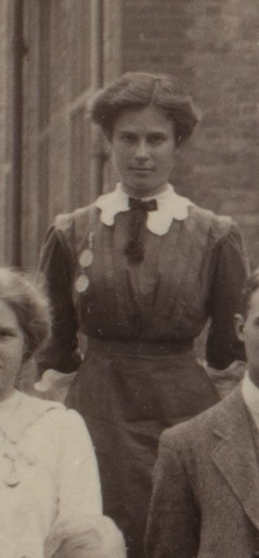 Formal photograph of woman standing outside. She is facing the camera.