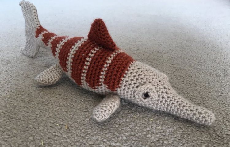 A grey and burgundy crochet ichthyosaur